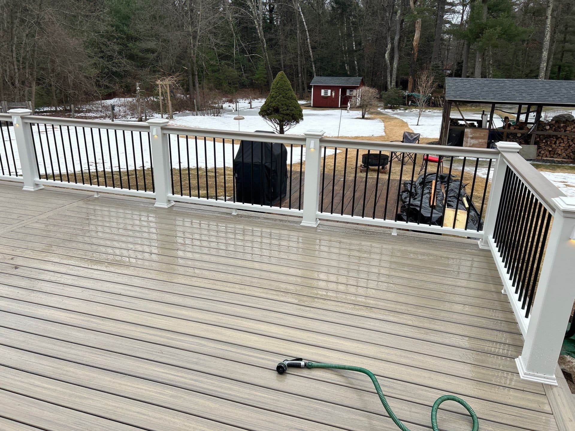 Composite deck with railings and potted trees on a Central Connecticut home