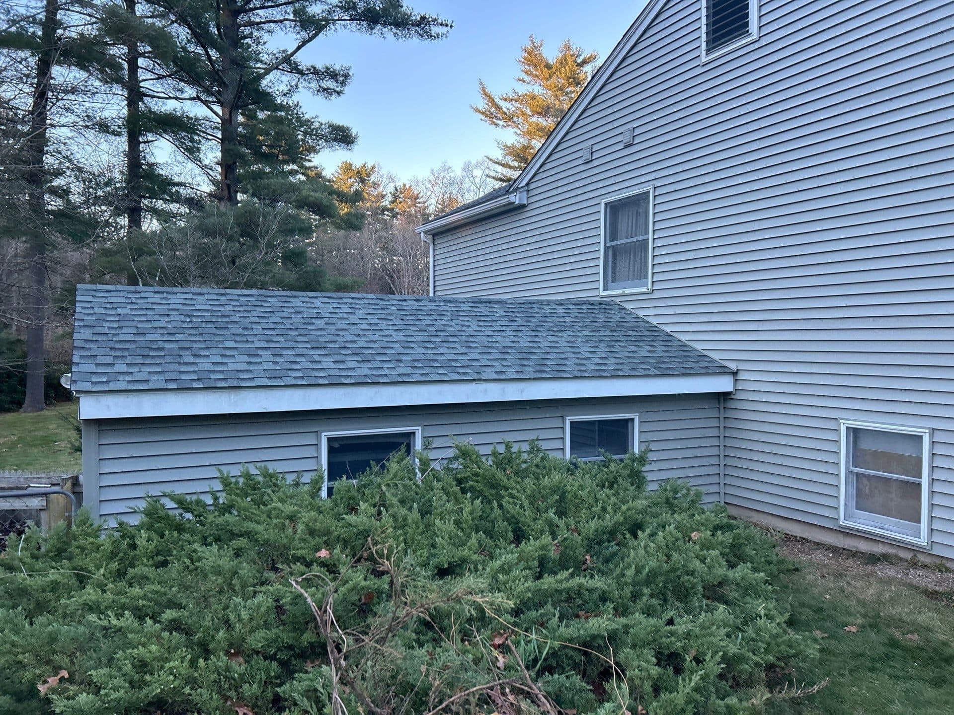 Finished blue home exterior with fresh landscaping in Central Connecticut