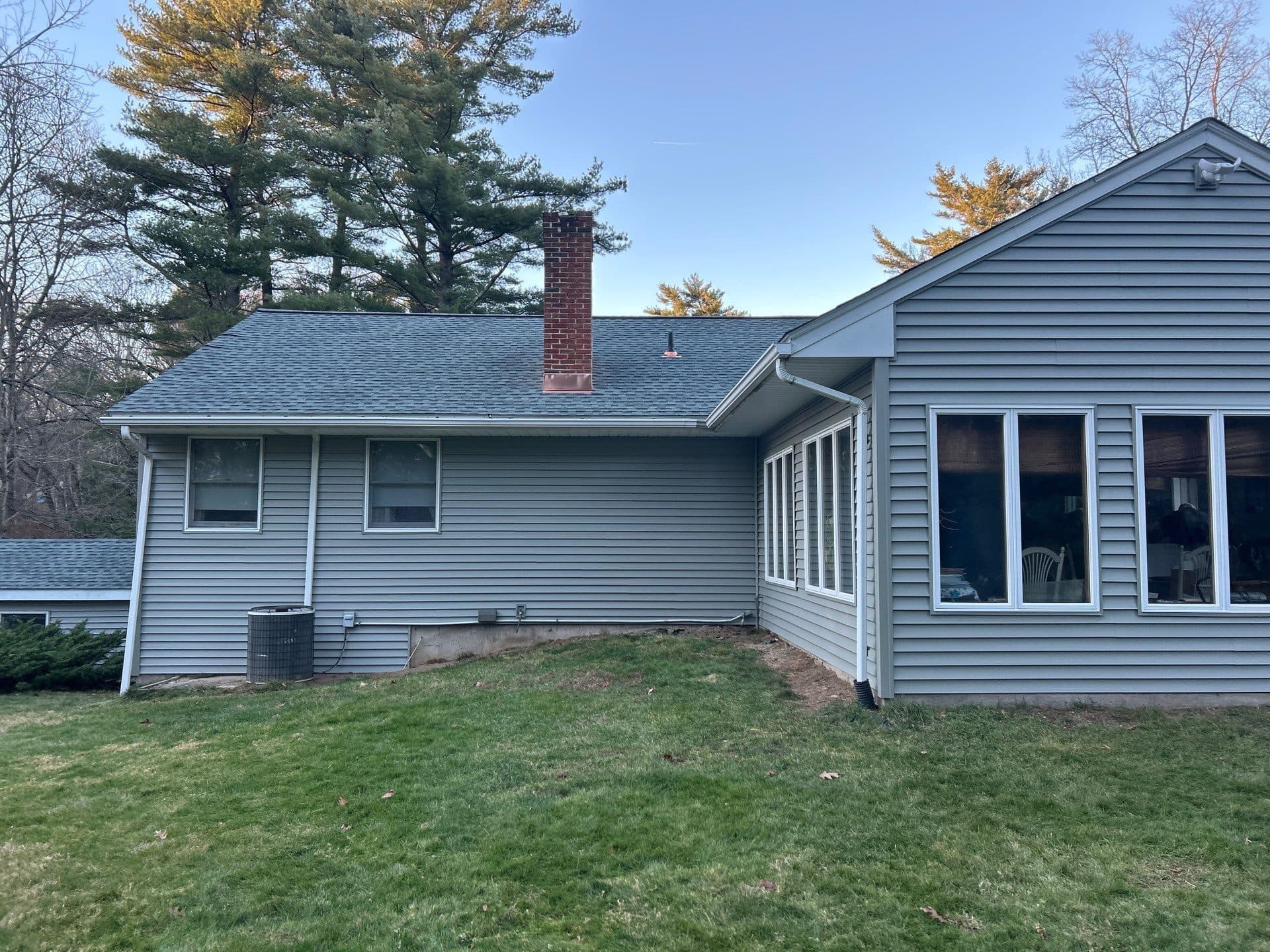 Blue home exterior with a sunroom addition in Central Connecticut