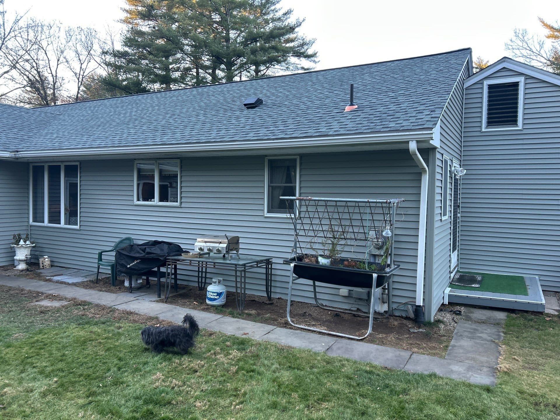Gray home exterior with a rear patio in Central Connecticut