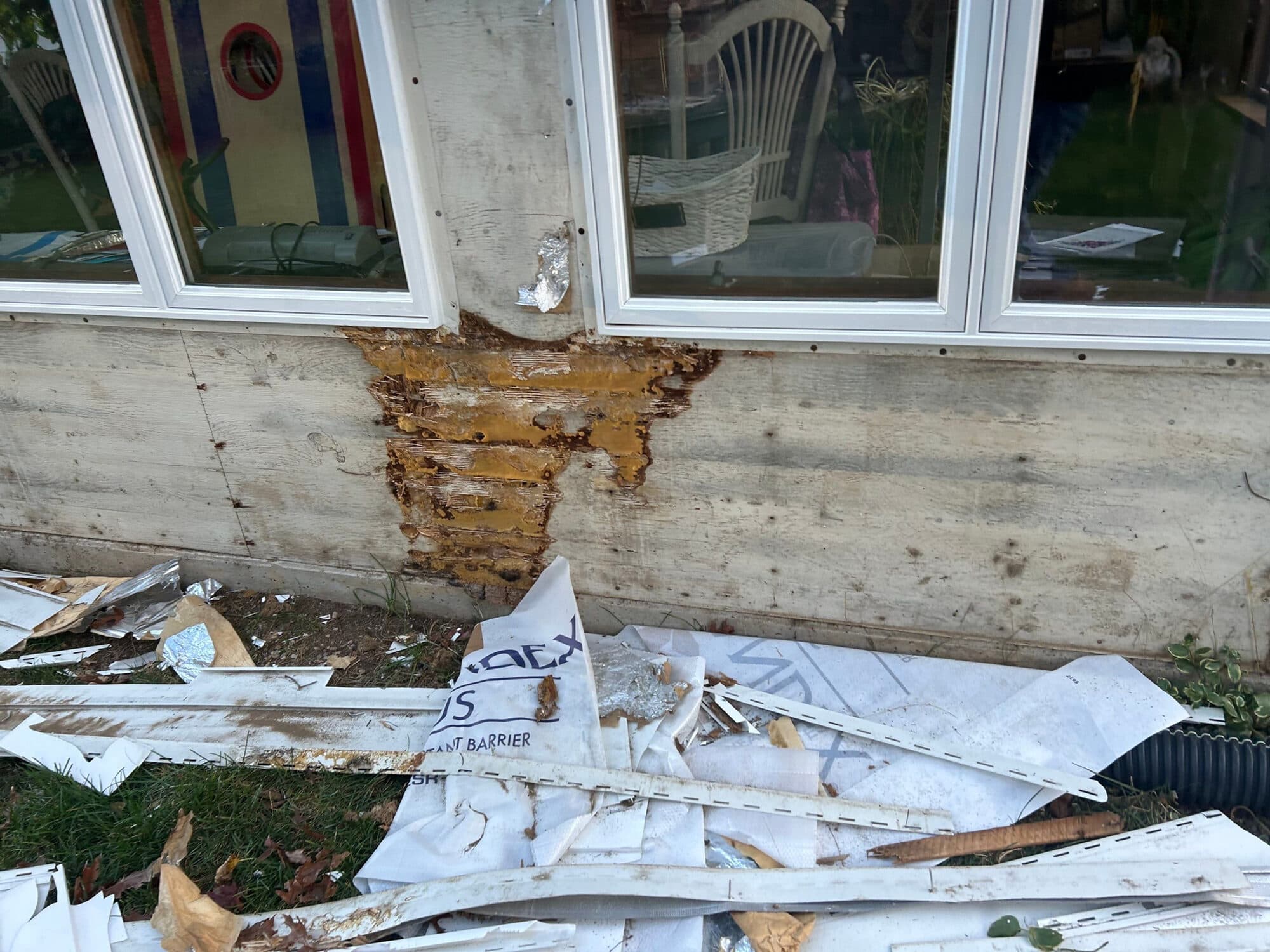 Water-damaged window and siding exposed during a storm-damage repair on a Connecticut home
