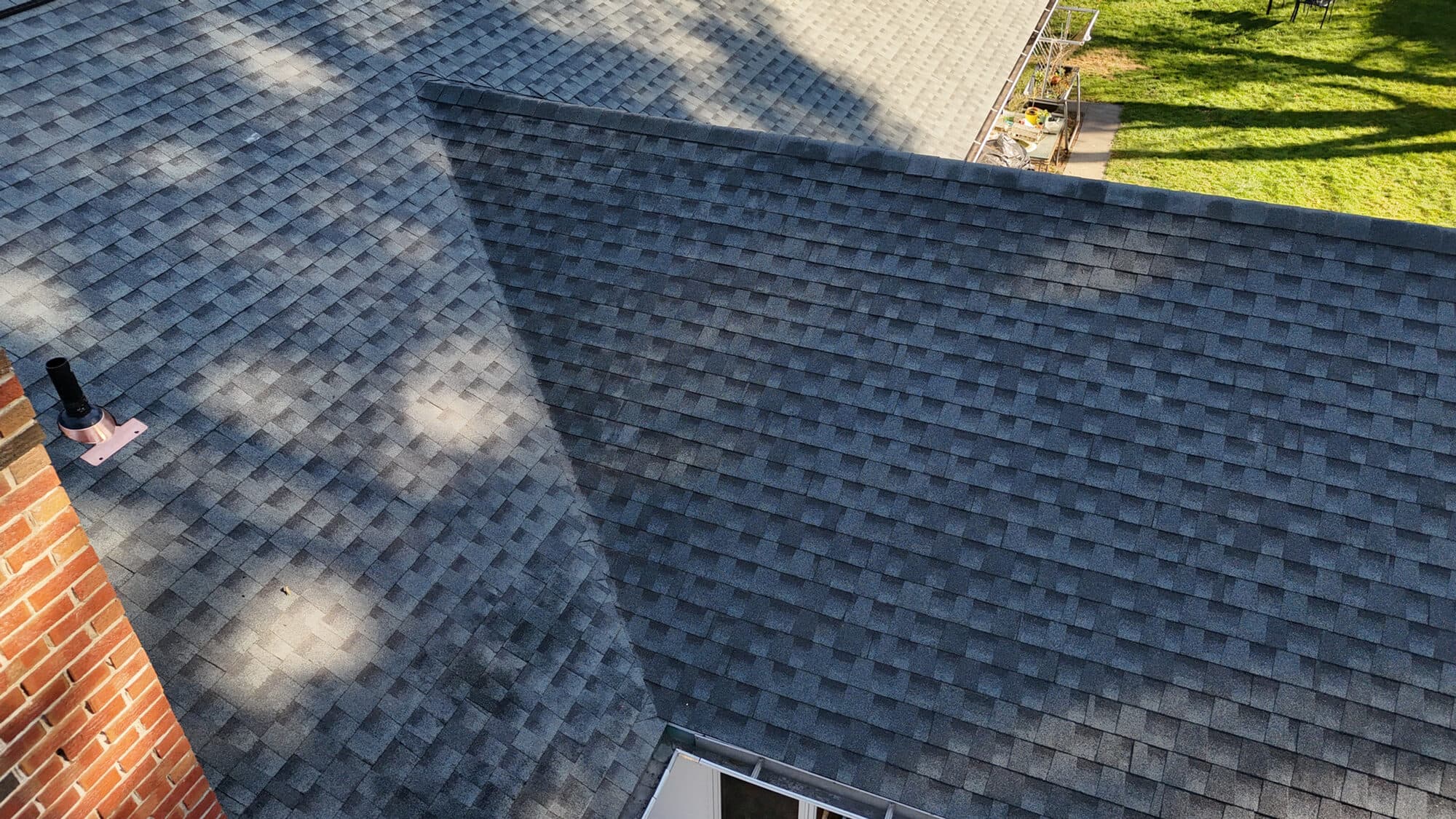 Close inspection of a Central Connecticut roof during a storm-damage claim assessment